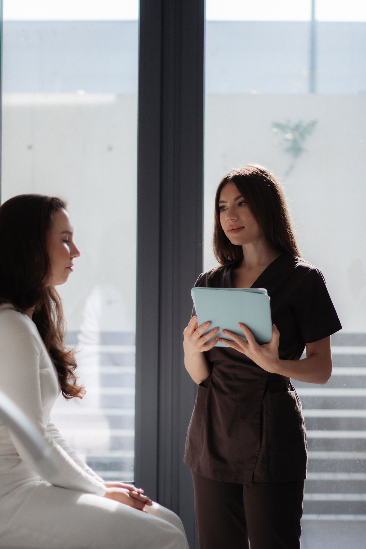 Patient speaking with an aesthetic healthcare professional during a private consultation