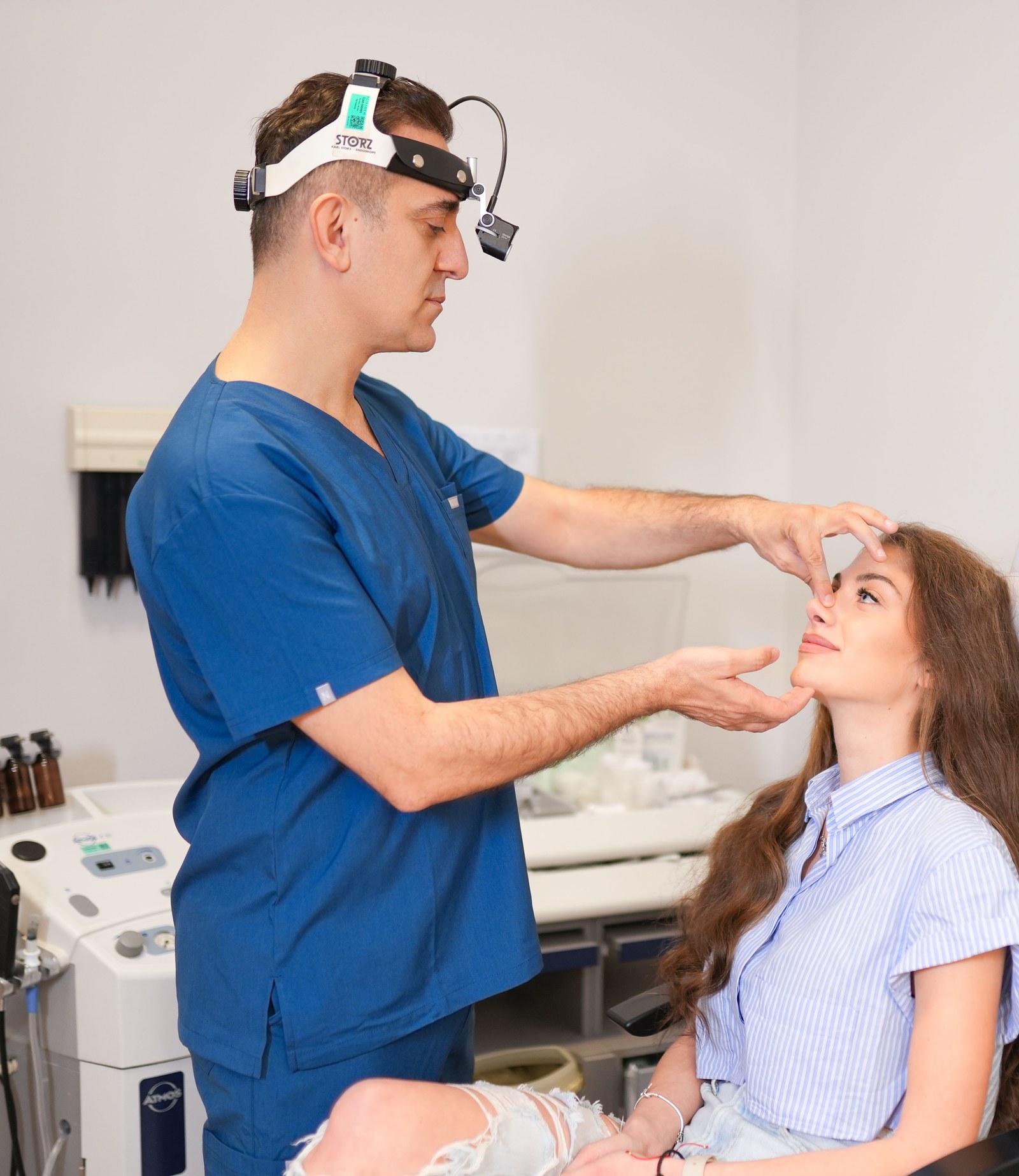 Plastic surgeon assessing a patient’s facial proportions during an aesthetic surgery consultation
